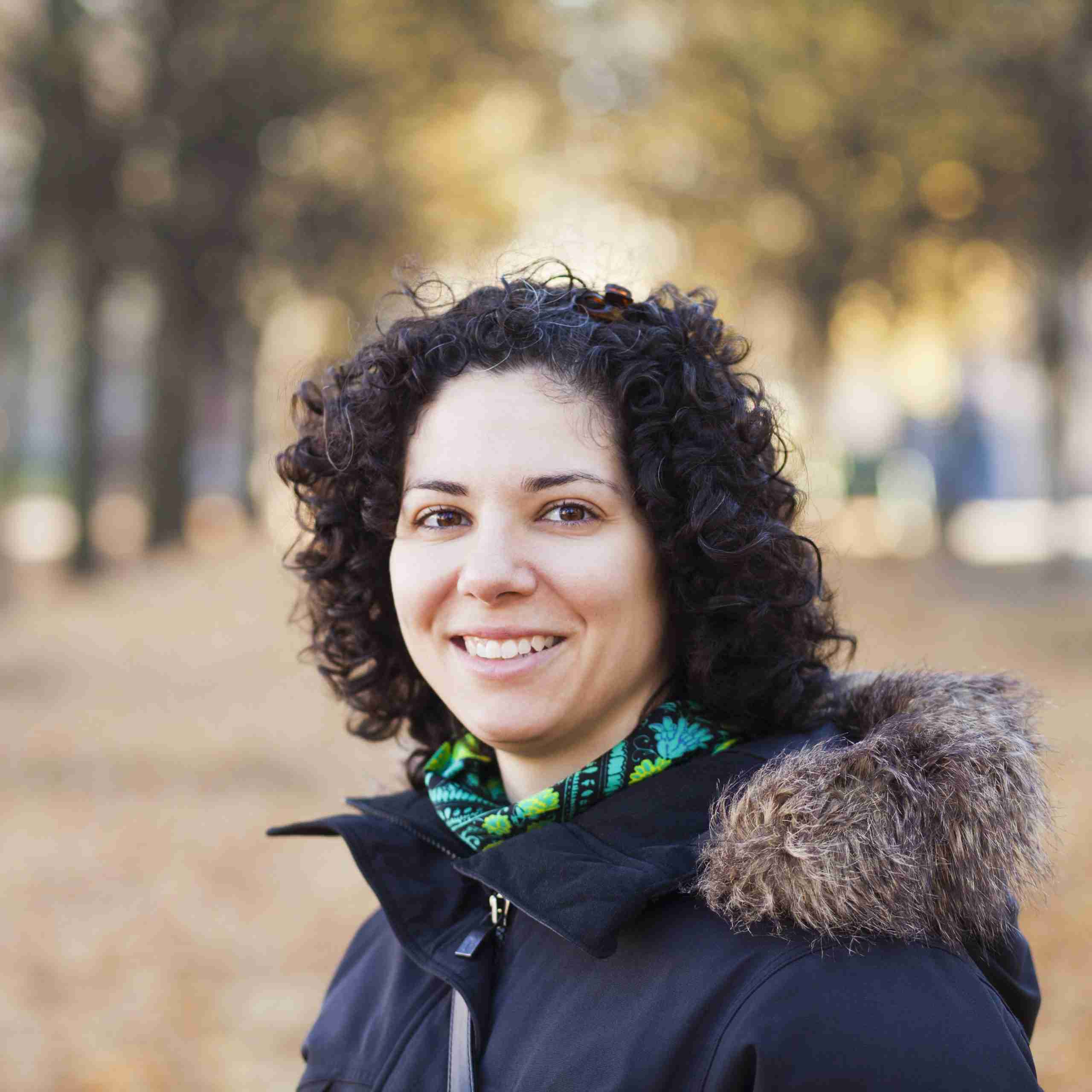 portrait-of-happy-woman-with-curly-hair-at-park